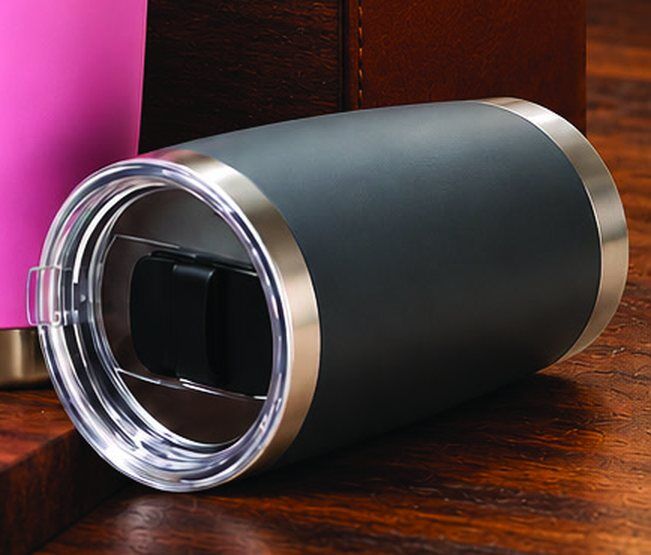 Close-up of a charcoal powder-coated steel tumbler lying on its side, showing the clear slider lid with a stainless steel rim